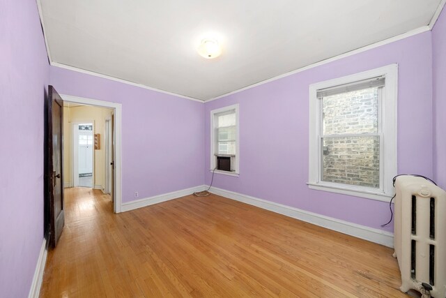 5010 N California Ave, Chicago, IL 60625 - unfurnished room featuring radiator, ornamental molding, plenty of natural light, and light wood-type flooring