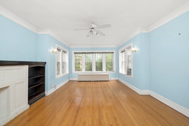 5010 N California Ave, Chicago, IL 60625 - unfurnished living room with radiator heating unit, ceiling fan, wood finished floors, ornamental molding, and a fireplace