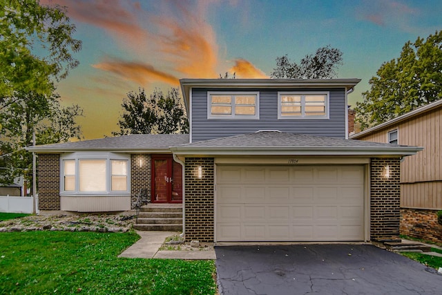 17804 Pebblewood Ln, Hazel Crest, IL 60429 - view of front facade with asphalt driveway, brick siding, a garage, and entry steps