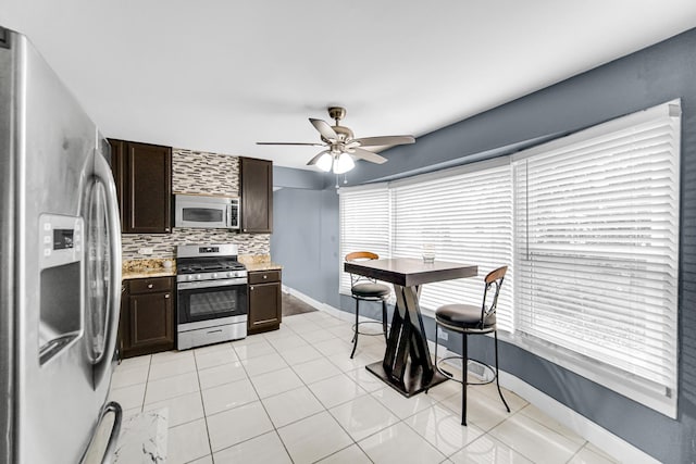 17804 Pebblewood Ln, Hazel Crest, IL 60429 - kitchen featuring appliances with stainless steel finishes, dark brown cabinetry, decorative backsplash, and light countertops