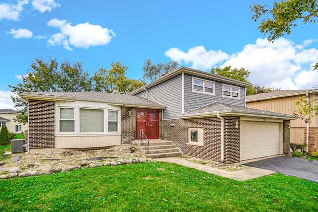 17804 Pebblewood Ln, Hazel Crest, IL 60429 - split level home featuring brick siding, driveway, an attached garage, and a front yard