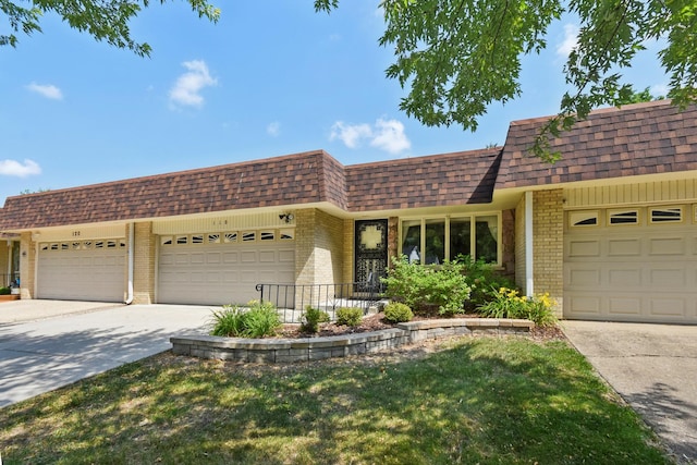 110 Meadowbrook Ln Unit 110, Morris, IL 60450 - front of property with brick siding, a shingled roof, driveway, and an attached garage