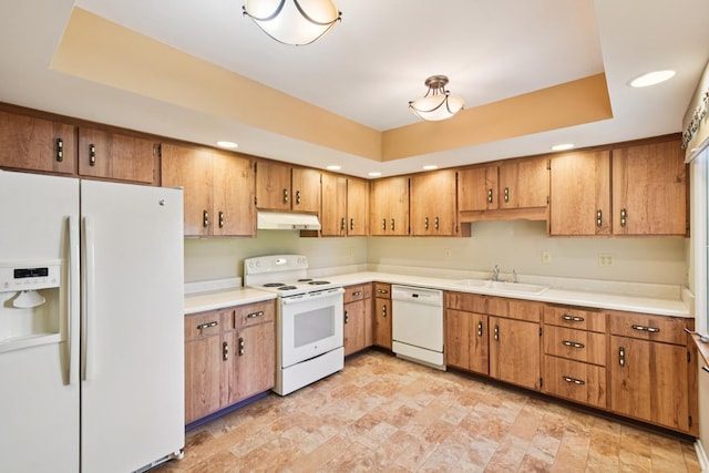 110 Meadowbrook Ln Unit 110, Morris, IL 60450 - kitchen with white appliances, under cabinet range hood, a raised ceiling, brown cabinets, and recessed lighting
