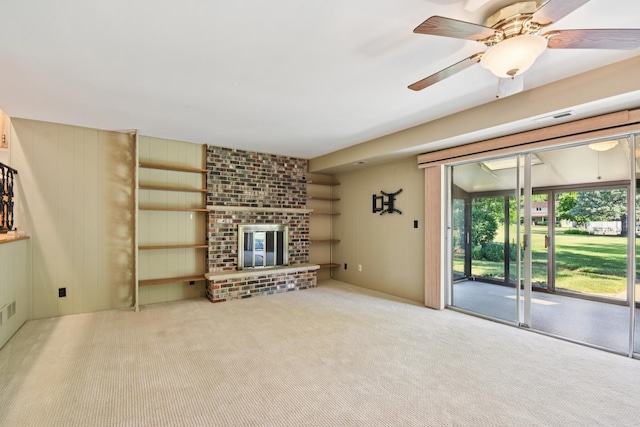 110 Meadowbrook Ln Unit 110, Morris, IL 60450 - unfurnished living room with carpet flooring, a ceiling fan, a fireplace, and wood walls