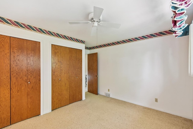 110 Meadowbrook Ln Unit 110, Morris, IL 60450 - unfurnished bedroom with carpet floors, multiple closets, and ceiling fan