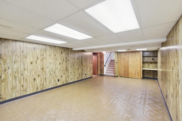 110 Meadowbrook Ln Unit 110, Morris, IL 60450 - finished below grade area featuring wood walls, a paneled ceiling, tile patterned floors, and stairs