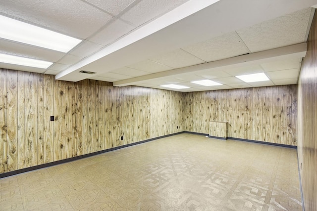 110 Meadowbrook Ln Unit 110, Morris, IL 60450 - finished basement with a paneled ceiling, tile patterned floors, and wood walls