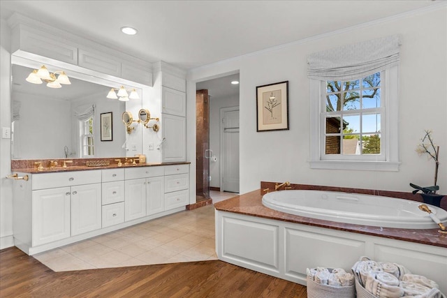 355 Myrtle St, Winnetka, IL 60093 - full bath featuring double vanity, a garden tub, crown molding, a chandelier, and wood finished floors