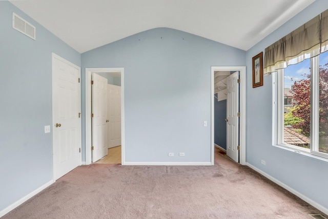 768 Fieldstone Dr, Lake Villa, IL 60046 - unfurnished bedroom featuring vaulted ceiling, light colored carpet, and a spacious closet