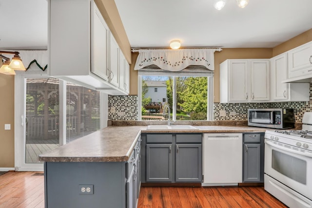 768 Fieldstone Dr, Lake Villa, IL 60046 - kitchen featuring white appliances, gray cabinetry, tasteful backsplash, and wood finished floors