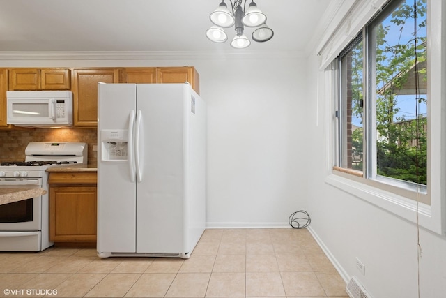 2208 Foster St Unit A, Evanston, IL 60201 - kitchen with white appliances, plenty of natural light, tasteful backsplash, light tile patterned floors, and crown molding