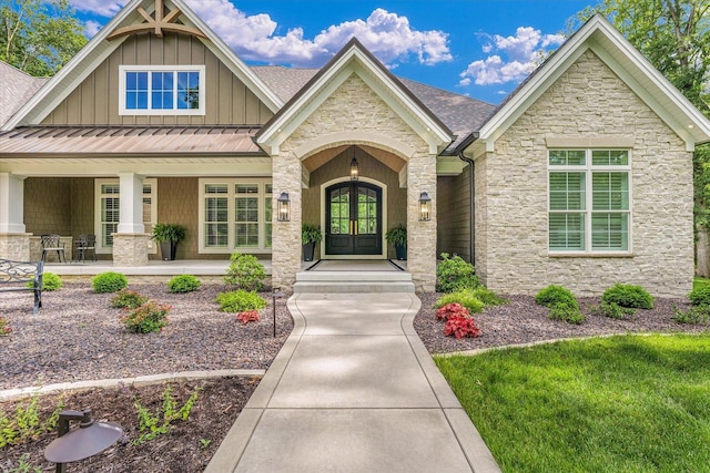 2611 Private Access 424, Mahomet, IL 61853 - view of front of home with stone siding, french doors, board and batten siding, and a porch