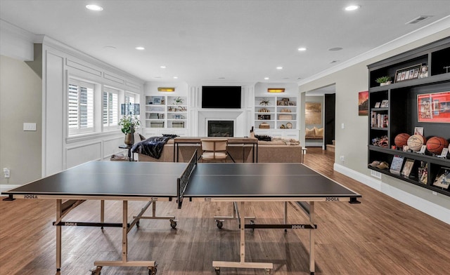 2611 Private Access 424, Mahomet, IL 61853 - rec room featuring a glass covered fireplace, wood finished floors, built in shelves, recessed lighting, and ornamental molding