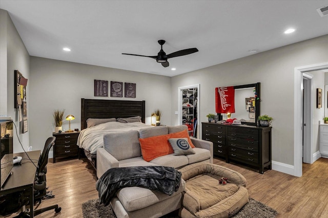 2611 Private Access 424, Mahomet, IL 61853 - bedroom with light wood-style flooring, a walk in closet, recessed lighting, a ceiling fan, and a closet