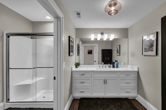 2611 Private Access 424, Mahomet, IL 61853 - bathroom featuring wood finished floors, vanity, and a stall shower