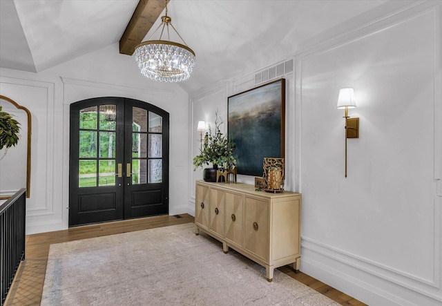 2611 Private Access 424, Mahomet, IL 61853 - entryway featuring french doors, a chandelier, light wood-style flooring, a decorative wall, and arched walkways