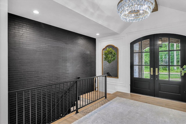2611 Private Access 424, Mahomet, IL 61853 - entrance foyer with wood finished floors, french doors, a chandelier, lofted ceiling, and arched walkways