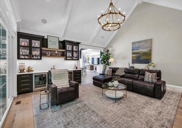 2611 Private Access 424, Mahomet, IL 61853 - living room featuring wine cooler, light wood-type flooring, a dry bar, beam ceiling, and a chandelier
