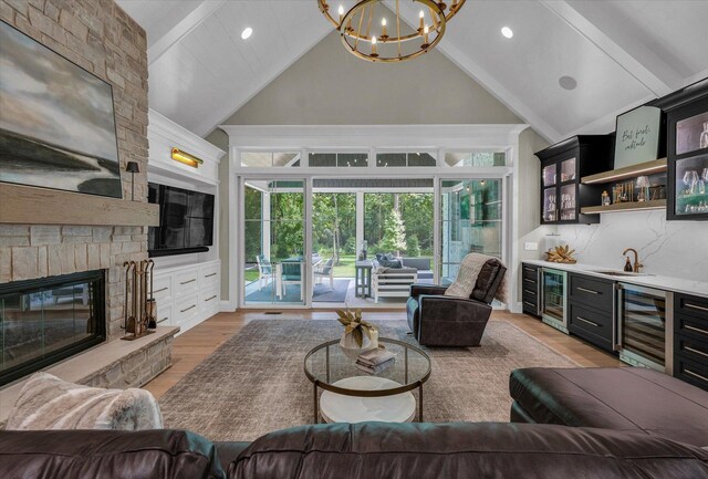 2611 Private Access 424, Mahomet, IL 61853 - living room featuring wine cooler, wet bar, a chandelier, high vaulted ceiling, and light wood-style floors