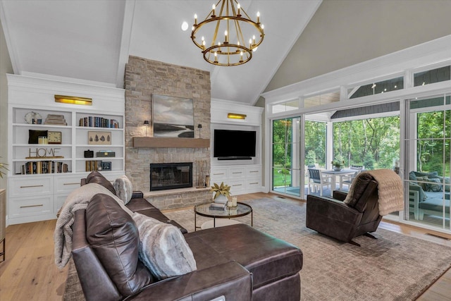 2611 Private Access 424, Mahomet, IL 61853 - living room featuring high vaulted ceiling, wood finished floors, a chandelier, and a stone fireplace