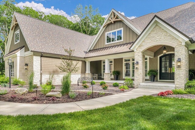 2611 Private Access 424, Mahomet, IL 61853 - craftsman house featuring stone siding, a porch, roof with shingles, a standing seam roof, and board and batten siding