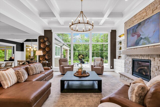 2611 Private Access 424, Mahomet, IL 61853 - living room featuring a chandelier, a stone fireplace, beam ceiling, coffered ceiling, and ornamental molding