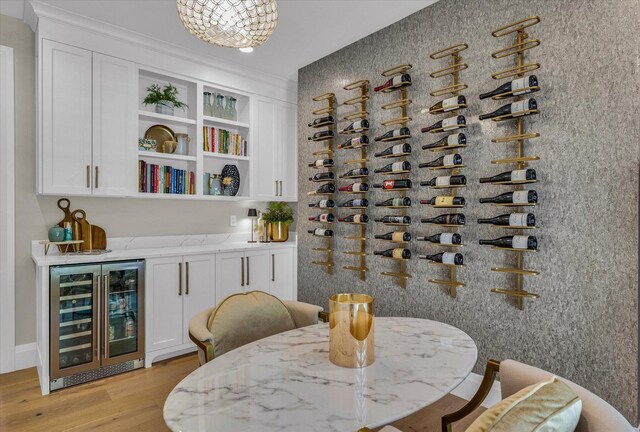 2611 Private Access 424, Mahomet, IL 61853 - wine area with wine cooler, light wood-style flooring, and a bar