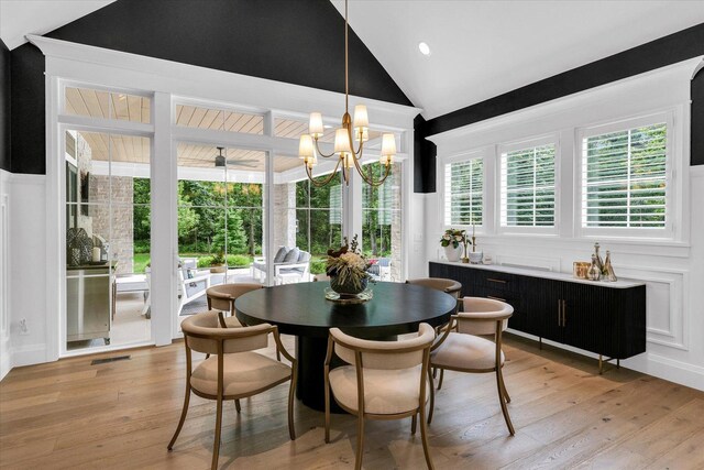 2611 Private Access 424, Mahomet, IL 61853 - dining space featuring vaulted ceiling, a chandelier, and light wood-style floors
