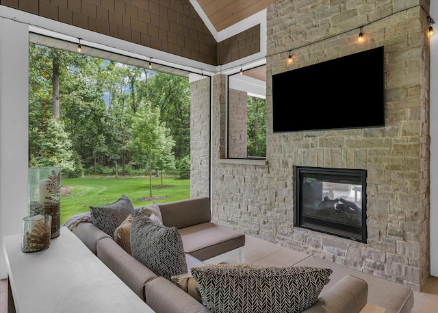 2611 Private Access 424, Mahomet, IL 61853 - living area featuring vaulted ceiling, plenty of natural light, and an outdoor stone fireplace