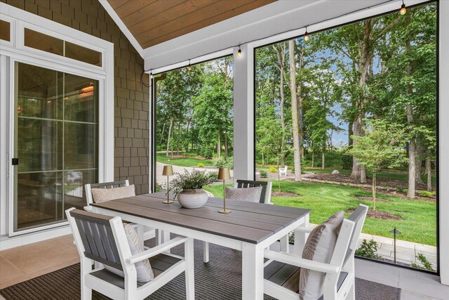 2611 Private Access 424, Mahomet, IL 61853 - sunroom / solarium featuring vaulted ceiling, outdoor dining area, and view of wooded area