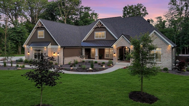 2611 Private Access 424, Mahomet, IL 61853 - craftsman-style house with stone siding, a standing seam roof, a front yard, and a porch