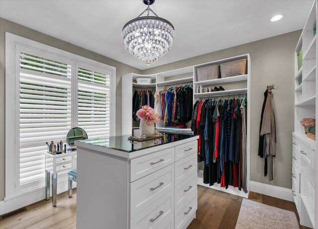 2611 Private Access 424, Mahomet, IL 61853 - walk in closet with a chandelier and light wood-style flooring