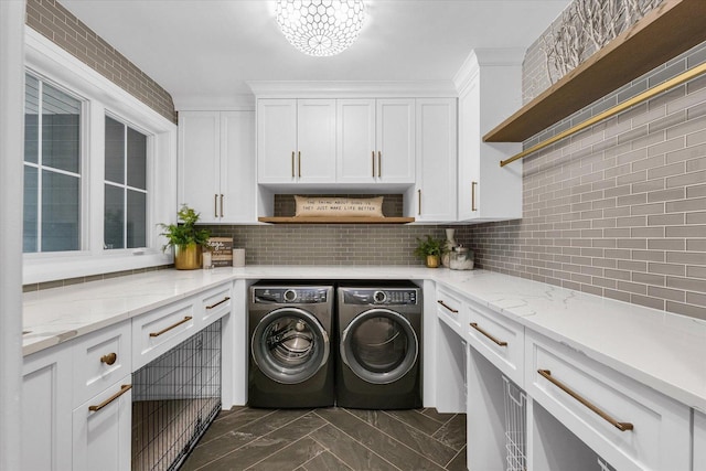 2611 Private Access 424, Mahomet, IL 61853 - washroom with washer and clothes dryer, cabinet space, dark marble finish flooring, and a chandelier