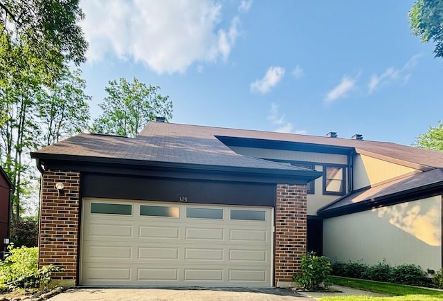 325 Shadowbend Dr, Wheeling, IL 60090 - view of front of house featuring brick siding, a shingled roof, driveway, and an attached garage