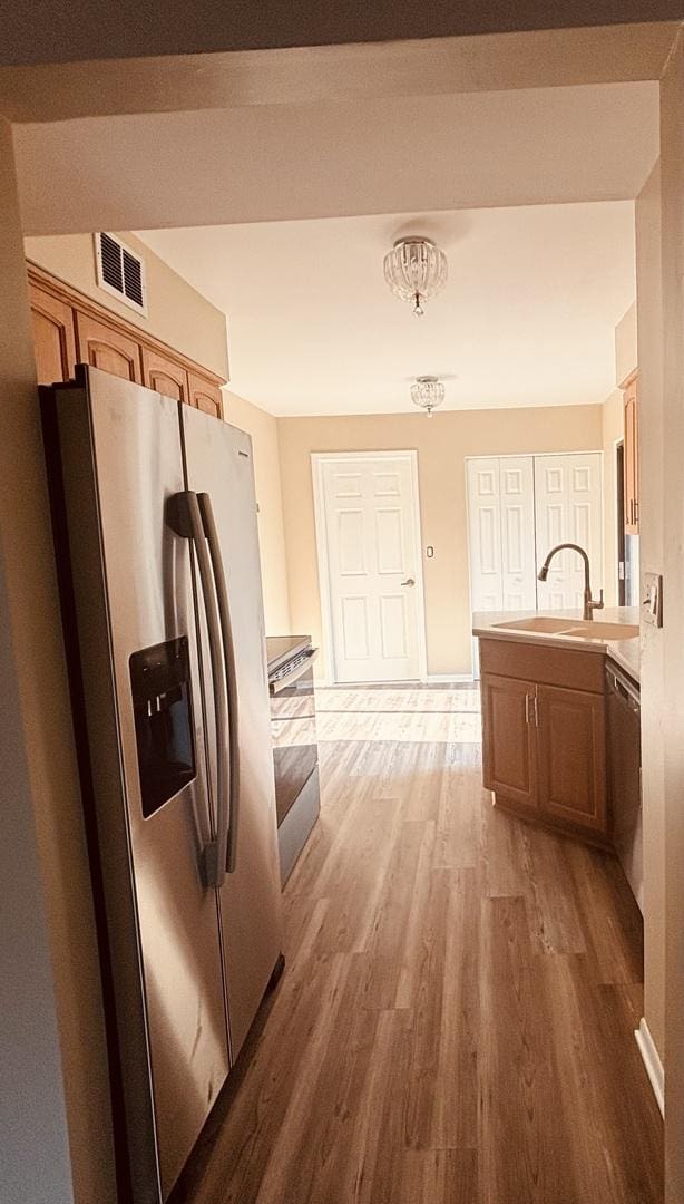 325 Shadowbend Dr, Wheeling, IL 60090 - kitchen with appliances with stainless steel finishes, light wood-type flooring, a peninsula, and light countertops