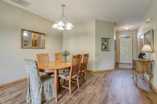 13504 S Buckthorn Ln, Plainfield, IL 60544 - dining area with wood finished floors and a chandelier