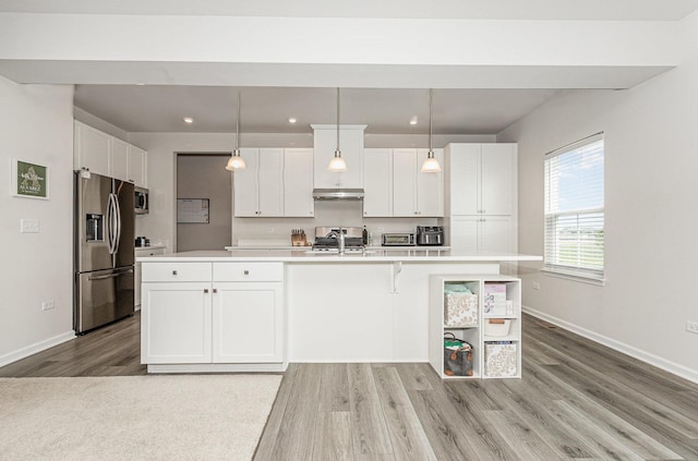 3068 Grande Trl, Yorkville, IL 60560 - kitchen featuring stainless steel appliances, light wood finished floors, light countertops, white cabinets, and an island with sink