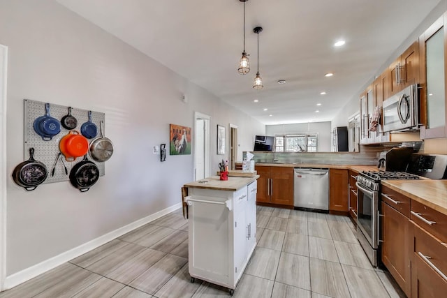 2150 W Coulter St, Chicago, IL 60608 - kitchen featuring appliances with stainless steel finishes, a peninsula, brown cabinetry, pendant lighting, and recessed lighting
