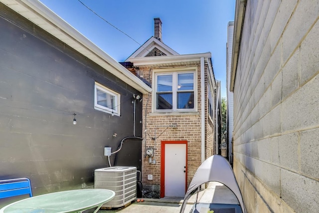 2150 W Coulter St, Chicago, IL 60608 - view of property exterior featuring a central AC unit and brick siding