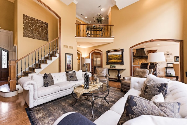 7N230 Sims Ln, Saint Charles, IL 60175 - living area with arched walkways, a high ceiling, stairway, and wood finished floors