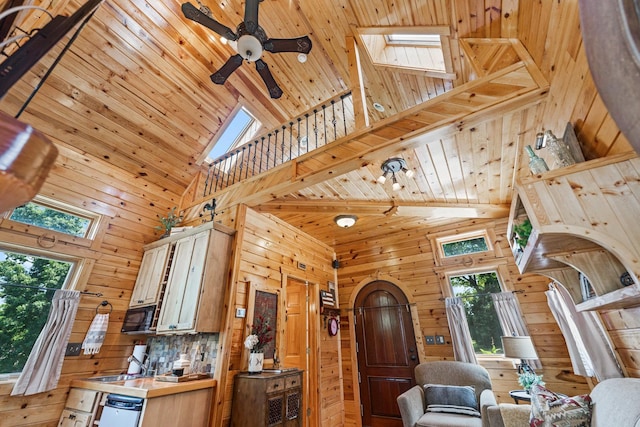 7N230 Sims Ln, Saint Charles, IL 60175 - living area with high vaulted ceiling, a skylight, wooden walls, plenty of natural light, and wooden ceiling