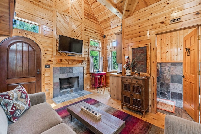 7N230 Sims Ln, Saint Charles, IL 60175 - living area featuring healthy amount of natural light, hardwood / wood-style floors, wooden walls, high vaulted ceiling, and a fireplace