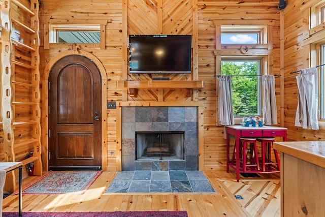 7N230 Sims Ln, Saint Charles, IL 60175 - living area featuring hardwood / wood-style floors, wood walls, and a tile fireplace