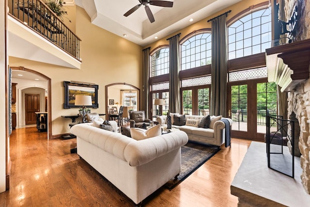 7N230 Sims Ln, Saint Charles, IL 60175 - living room featuring arched walkways, a ceiling fan, a towering ceiling, wood finished floors, and recessed lighting
