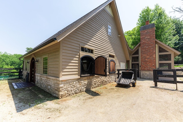 7N230 Sims Ln, Saint Charles, IL 60175 - view of side of home with stone siding and a chimney