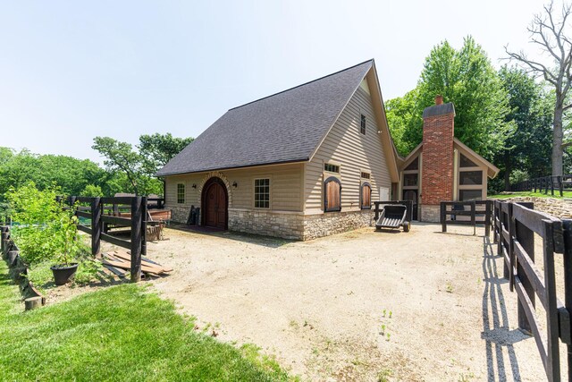 7N230 Sims Ln, Saint Charles, IL 60175 - view of side of property featuring roof with shingles and stone siding