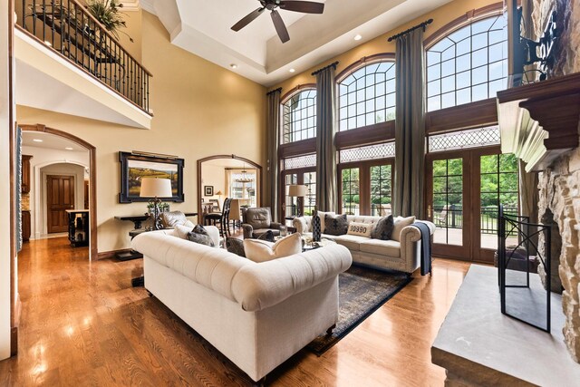 7N230 Sims Ln, Saint Charles, IL 60175 - living room featuring arched walkways, a ceiling fan, a towering ceiling, wood finished floors, and recessed lighting