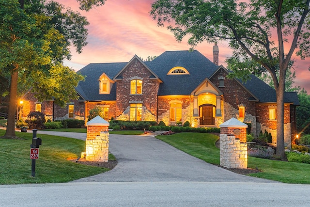 7N230 Sims Ln, Saint Charles, IL 60175 - view of front facade featuring a lawn, brick siding, a chimney, and a shingled roof