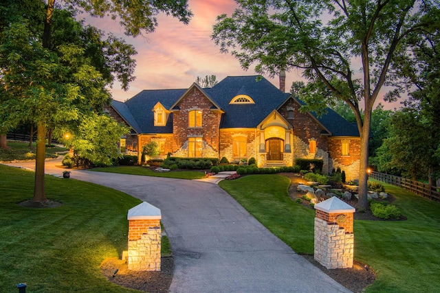 7N230 Sims Ln, Saint Charles, IL 60175 - view of front of house featuring a chimney, stone siding, and curved driveway