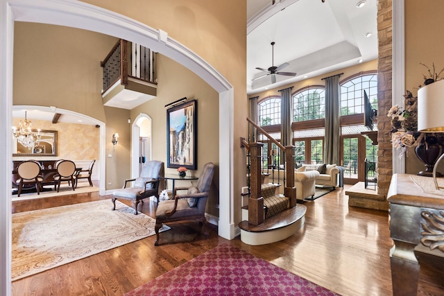 7N230 Sims Ln, Saint Charles, IL 60175 - foyer featuring a towering ceiling, arched walkways, wood finished floors, ceiling fan, and a chandelier